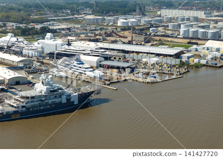 Construction shipyard for assembling of luxury yachts. Commercial dock for sea ships manufacturing Construction shipyard for assembling of luxury yachts. Commercial dock for sea ships manufacturing 141427720