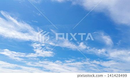 A photograph of a blue sky and clouds on an early summer day. A photograph of a blue sky and clouds on an early summer day. 141428499
