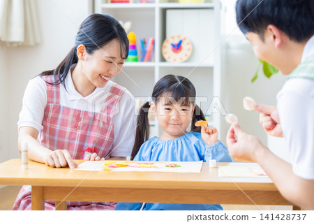 Childcare image: A girl and a childcare worker who work Childcare image: A girl and a childcare worker who work 141428737
