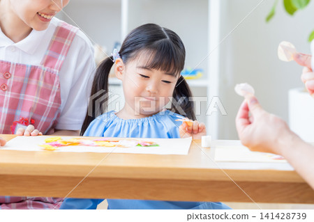Childcare image: A girl and a childcare worker who work Childcare image: A girl and a childcare worker who work 141428739
