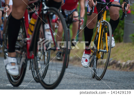A close-up of the feet in a triathlon and cycling competition, capturing the excitement of the event. A close-up of the feet in a triathlon and cycling competition, capturing the excitement of the event. 141429139