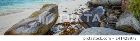 Fjord in rainy weather. Rocky beach in evening, White sand on the beach. Beautiful nature of Norway. Lofoten islands Fjord in rainy weather. Rocky beach in evening, White sand on the beach. Beautiful nature of Norway. Lofoten islands 141429972