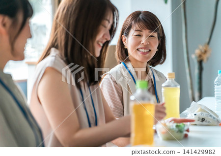 Businesswoman having lunch in company cafeteria/break room Businesswoman having lunch in company cafeteria/break room 141429982
