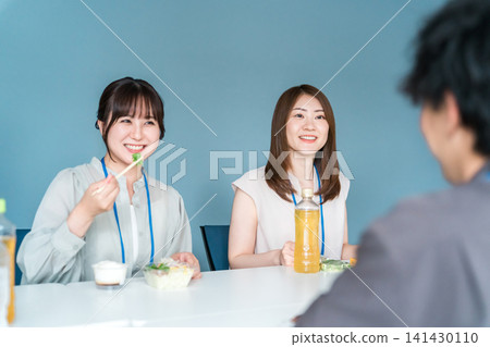 穿著工作服的商人和女士們在休息室吃午餐 穿著工作服的商人和女士們在休息室吃午餐 141430110