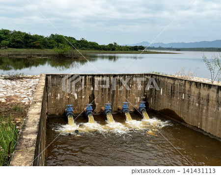 Agricultural irrigation system concrete spillway structure, showcasing rural water resource management, drainage pipes discharging inflow, reservoir hydraulics, and civil engineering Agricultural irrigation system concrete spillway structure, showcasing rural water resource management, drainage pipes discharging inflow, reservoir hydraulics, and civil engineering 141431113