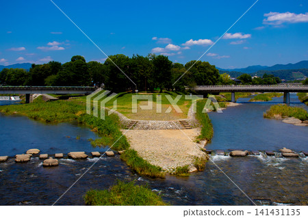 Kamogawa Delta: The confluence of the Kamogawa and Takasegawa rivers, a pilgrimage site for fans. Kamogawa Delta: The confluence of the Kamogawa and Takasegawa rivers, a pilgrimage site for fans. 141431135