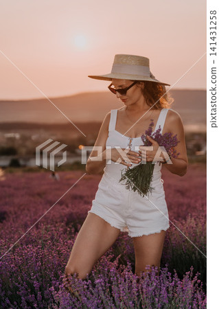 Lavender woman sunset, a young lady wearing a summer hat and holding flowers in a purple blooming field at golden hour Lavender woman sunset, a young lady wearing a summer hat and holding flowers in a purple blooming field at golden hour 141431258
