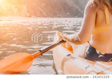 Kayaking, Woman, River: A woman kayaks down a river on a sunny day. 141431329