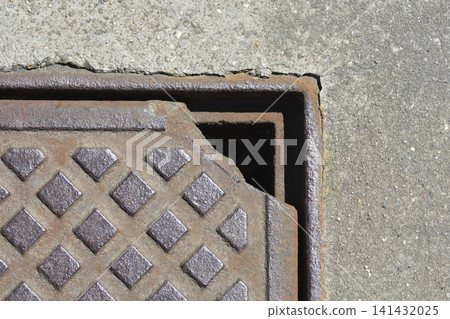 Broken cast iron manhole cover background Broken cast iron manhole cover background 141432025