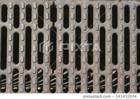 Rusty metal storm drain grate background Rusty metal storm drain grate background 141432034
