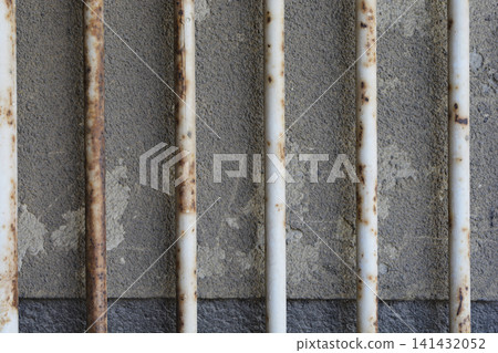 Rusty Metal Bars In Front Of Old Concrete Wall Rusty Metal Bars In Front Of Old Concrete Wall 141432052