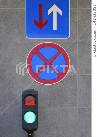 Traffic Light And Road Signs On Grey Wall Traffic Light And Road Signs On Grey Wall 141432053