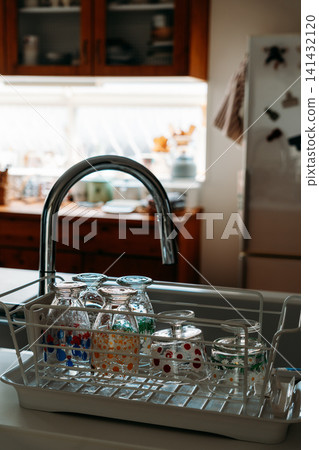 Kitchen viewed through a dish drying rack Kitchen viewed through a dish drying rack 141432120