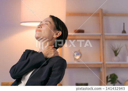 A woman in a suit relaxing after work A woman in a suit relaxing after work 141432943