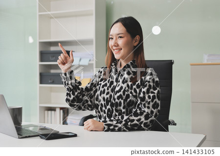 Confident asian business woman standing in modern office Confident asian business woman standing in modern office 141433105