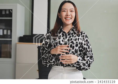 Confident asian business woman standing in modern office Confident asian business woman standing in modern office 141433119