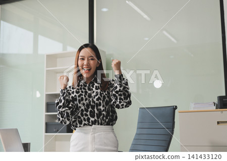 Confident asian business woman standing in modern office Confident asian business woman standing in modern office 141433120