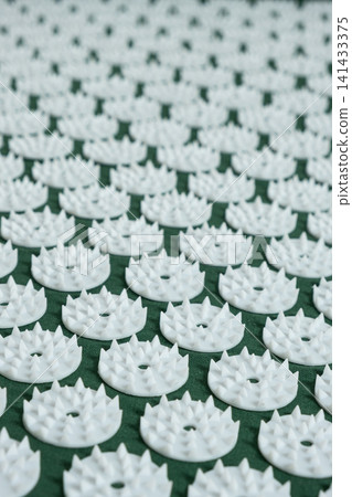 Extreme close up of plastic spikes on therapeutic acupressure applicator Extreme close up of plastic spikes on therapeutic acupressure applicator 141433375