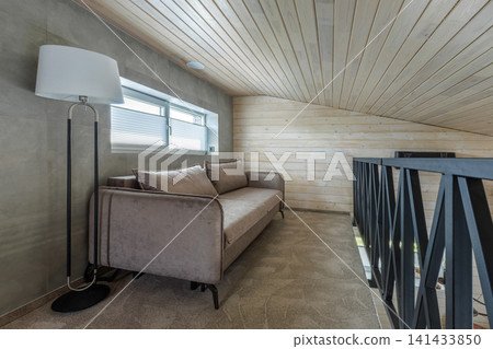 Mezzanine Floor Interior with Sofa, Floor Lamp, and Metal Railing Mezzanine Floor Interior with Sofa, Floor Lamp, and Metal Railing 141433850