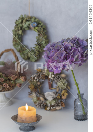 A still-life interior featuring hydrangeas and scented candles in a chic space. A still-life interior featuring hydrangeas and scented candles in a chic space. 141434363