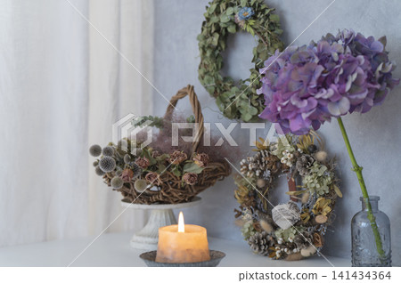 A still-life interior featuring hydrangeas and scented candles in a chic space. A still-life interior featuring hydrangeas and scented candles in a chic space. 141434364