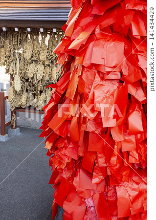 A statue of Fudo Myoo and straw sandals, covered in red slips bearing wishes, at Higashikaku-ji Temple in Kita Ward. A statue of Fudo Myoo and straw sandals, covered in red slips bearing wishes, at Higashikaku-ji Temple in Kita Ward. 141434429