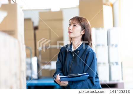 Female staff working in the warehouse Female staff working in the warehouse 141435218