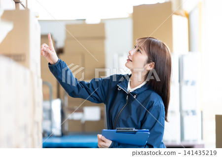 Female staff working in the warehouse Female staff working in the warehouse 141435219