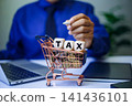 tax icon in wooden block placed on a stack of coins, representing the concepts of taxation, money preservation, economic growth, and future planning. businessman working background. 141436101