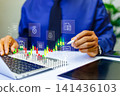 investment and finance concept, businessman holding virtual trading graph and blurred coins on hand, growing graph,  business investment profit and dividend saving growth 141436103