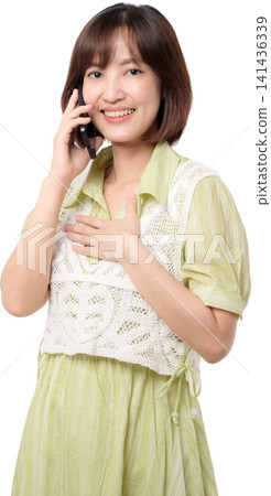 Asian woman talking on phone with smile on transparent background showing happy emotion while holding mobile device for communication in casual dress during workday. PNG file format 141436339