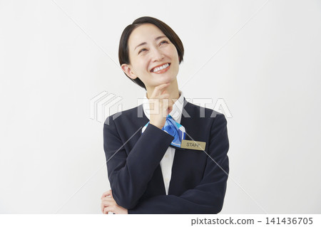 A female staff member in her 40s brainstorming ideas against a white background. A female staff member in her 40s brainstorming ideas against a white background. 141436705