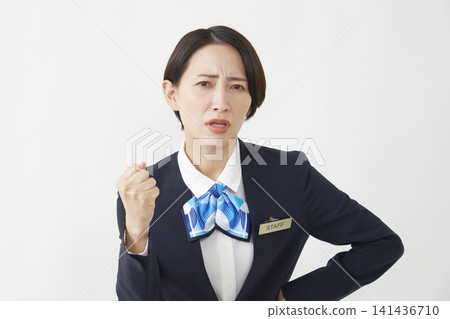 A female staff member in her 40s looks angry against a white background. A female staff member in her 40s looks angry against a white background. 141436710
