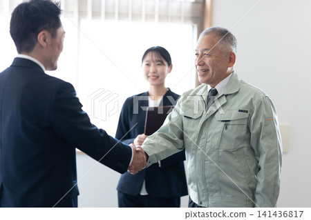 Executive and consultant shake hands Executive and consultant shake hands 141436817