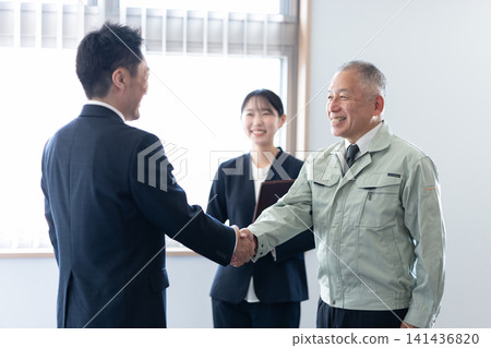 Executive and consultant shake hands Executive and consultant shake hands 141436820