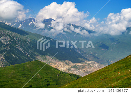 Expansive mountainous landscape featuring rolling hills Expansive mountainous landscape featuring rolling hills 141436877