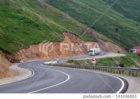 Winding road on mountain with truck Winding road on mountain with truck 141436883