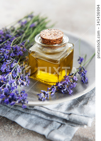 Lavender essential oil bottle with fresh purple flowers Lavender essential oil bottle with fresh purple flowers 141436994