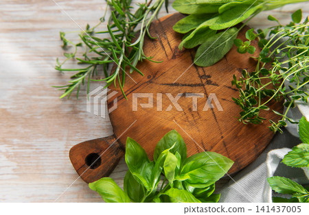 Fresh cooking herbs on wooden board preparing ingredients Fresh cooking herbs on wooden board preparing ingredients 141437005