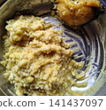 Clump of traditional yellow lentil rice khichdi with fried fish piece in steel bowl. Clump of traditional yellow lentil rice khichdi with fried fish piece in steel bowl. 141437097