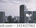 A monochrome cityscape reflected in a clear glass. 141437362