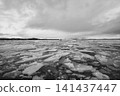 A landscape of Icelandic lakes with scattered, broken glaciers. 141437447