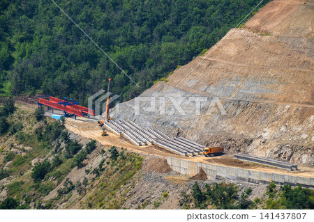 Highway construction in mountainous terrain with heavy machinery 141437807