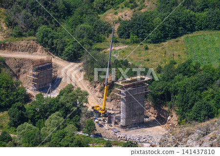Top-down photo of stone pillars and construction equipment Top-down photo of stone pillars and construction equipment 141437810