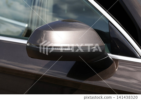 Brown modern car side mirror with integrated turn signal light, exterior detail of vehicle design, automotive equipment and safety feature for driver Brown modern car side mirror with integrated turn signal light, exterior detail of vehicle design, automotive equipment and safety feature for driver 141438320