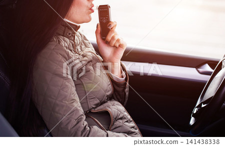 Female Driver Testing Breath For Alcohol Content Inside Automobile. Personal Sobriety Measurement. Copy space for text Female Driver Testing Breath For Alcohol Content Inside Automobile. Personal Sobriety Measurement. Copy space for text 141438338