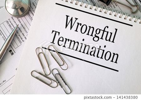 Wrongful Termination text on notebook with pen and paperclips on white background, labor law and employment concept Wrongful Termination text on notebook with pen and paperclips on white background, labor law and employment concept 141438380