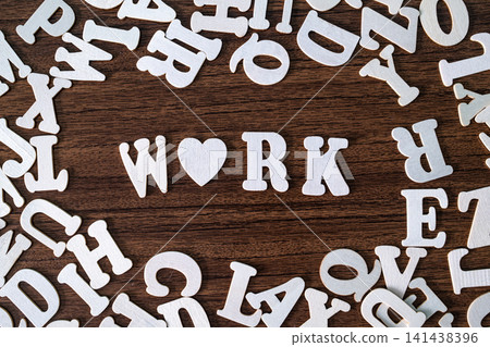 WORK word with heart symbol spelled with letter tiles on scattered letters wooden background, employment and career concept WORK word with heart symbol spelled with letter tiles on scattered letters wooden background, employment and career concept 141438396