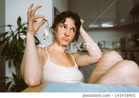 young woman holding remains pear young woman holding remains pear 141438401