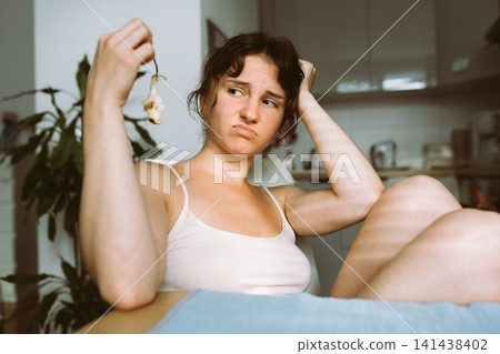 young woman holding remains pear 141438402